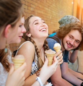 Group of urban teenage friends hanging out eating ice-cream.